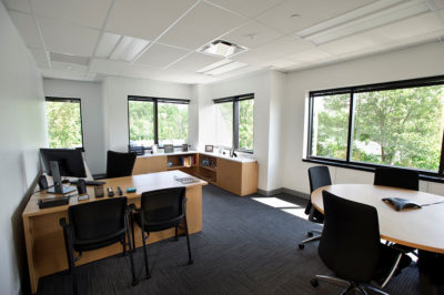 Corner Office with Desk, Chairs, Table, and Storage
